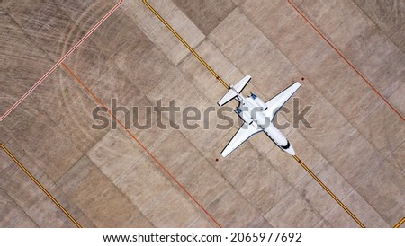 Aerial view of private business jet is waiting at the airport. Royalty-Free Stock Photo #2065977692