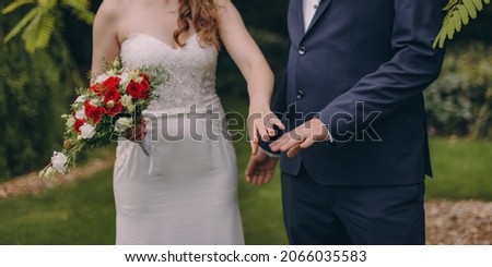 Picture of bride and groom with wedding ring. Young married couple holding hands, ceremony wedding day. Newly wed couple's hands with wedding rings.