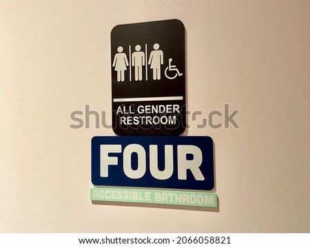 Close-up of all-gender and wheelchair accessible bathroom sign on a restroom door at a restaurant in New York City