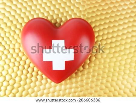 Red heart with cross sign on bright background