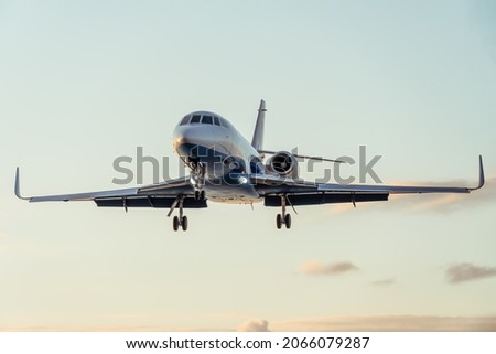 Close-up of a private plane against a beautiful gentle sky with clouds at sunset