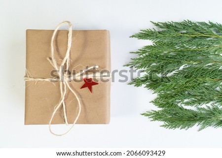 Christmas gift box with noel tree leaves christmas concept photo, top view white background