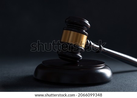 Judge's gavel on dark background, top view. Law concept