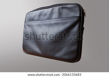 black leather folder with texture on a gray background. copy space.