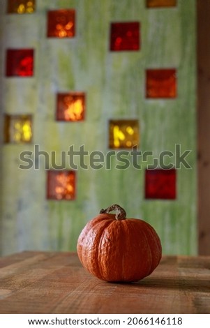 large orange pumpkin on a green background. pumpkin in the interior for decoration. preparation for Halloween celebration. fall decor. pumpkin in the kitchen for cooking dinner or for decorating home