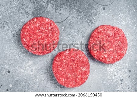 Raw Ground mince beef meat Burger steak cutlets. Gray background. Top view