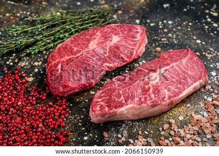 Raw Shoulder Top Blade cuts, beef meat steaks. Brown background. Top View Royalty-Free Stock Photo #2066150939