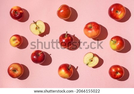Colorful fruit pattern of fresh red apples on pink background. Flat lay, top view, copy space for your text. Healthy concept
