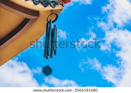 Pagoda curved roof building temple, metal big hanging wind sound bell chime effect melodious buddhism china. Day blue sky clouds background. Calm god religious peace quiet relax soul health mood Royalty-Free Stock Photo #2066181680