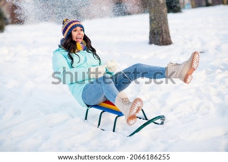 Full size photo of young funky funny crazy screaming positive woman riding fast speed sledge having fun winter holiday