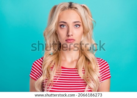 Photo of serious charming attractive young woman wear casual red striped t-shirt isolated on teal color background