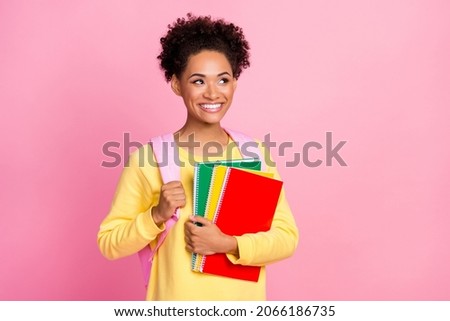 Photo of funny millennial brunette lady hold books look wear yellow shirt isolated on pink color background