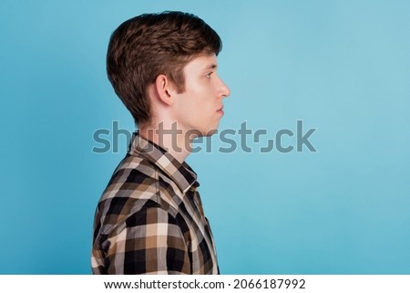Profile side photo of young guy calm peaceful wear casual outfit look empty space isolated over blue color background