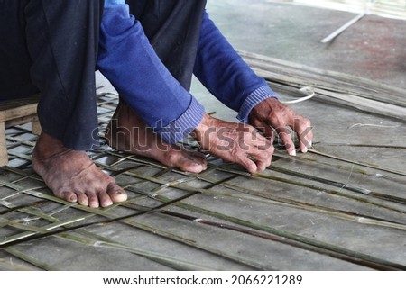 Ninh Binh, Vietnam - 30 Oct 2021: Vietnamese craftsmen are knitting bamboo frames Royalty-Free Stock Photo #2066221289