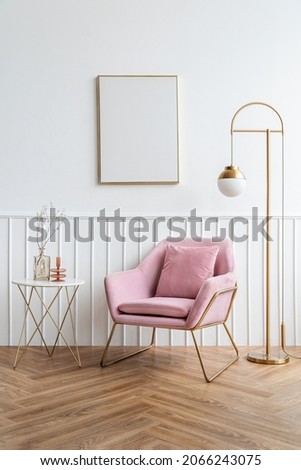 Blank picture frame by a pink velvet armchair Royalty-Free Stock Photo #2066243075