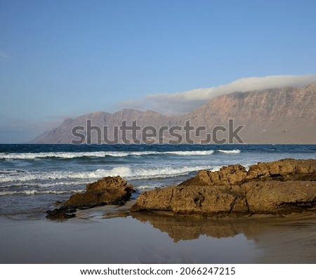 Famara beach at low tide, cliffs and blue sky, north of Lanzarote, Canary Islands