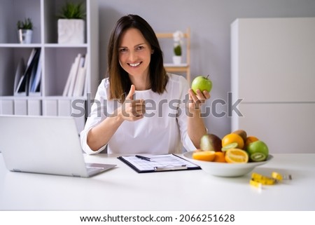 Female Nutritionist Or Dietitian In Laboratory Using Laptop