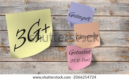 Sticky notes with the inscription "3G+, Geimpft, Genesen, Getestet", translation "3G +, Vaccinated, Recovered, Tested" on a wooden wall Royalty-Free Stock Photo #2066254724