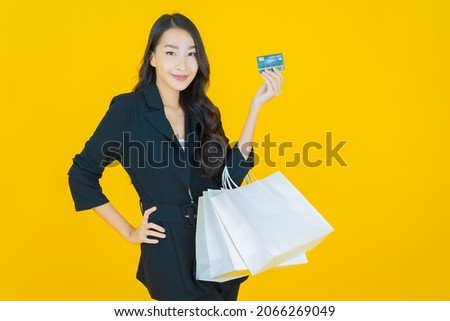 Portrait beautiful young asian woman smile with smart mobile phone on color background