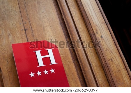 Hotel sign on a wooden door in Le Marais Paris
