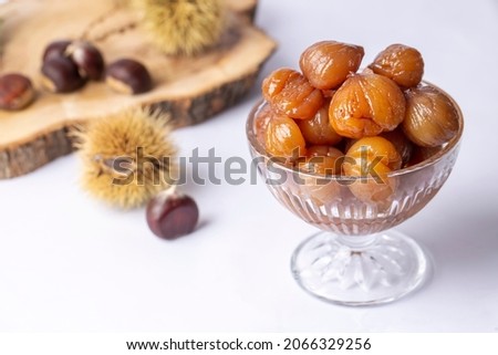 Chestnut dessert and chestnuts on a plate. Traditional delicious Turkish dessert; chestnut candies (Kestane Sekeri) Royalty-Free Stock Photo #2066329256