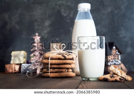 Milk for Santa Claus and Christmas cookies on dark background close-up and copy space concept...