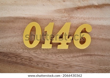 Golden Arabic numerals 0146 on a dark brown to white wood grain background.