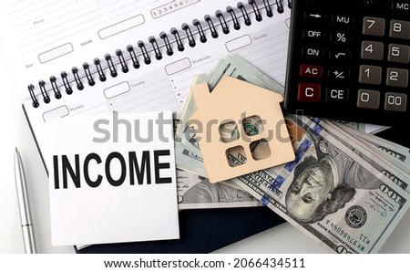 INCOME - the inscription of text on sticker on planning with dollars and calculator
