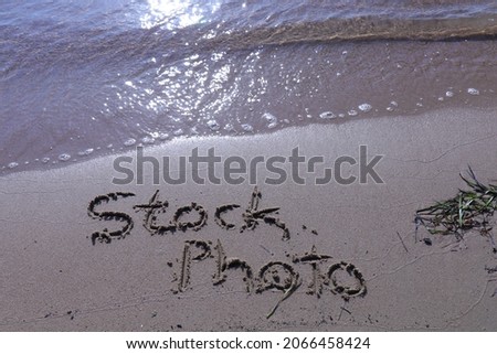 Stock photo sign letters on the summer beach sand