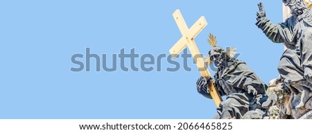 Banner with Column of Holy Trinity and Figures of Saints holding the cross in Prague, Czech Republic with copy space and blue sky solid background. Concept of religious and historical architecture