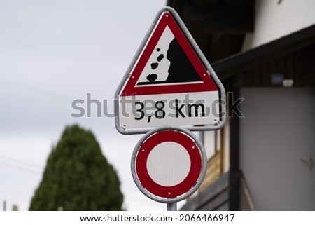 Traffic sign warning from rock fall ahead Axalp at Bernese Highlands on a grey cloudy autumn day. Photo taken October 19th, 2021, Brienz, Switzerland.