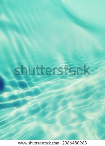 Closeup​ abstract​ of​ surface​ blue​ water​ for​ graphic​ design. Reflection​ of​ sunlight​ to​ surface​ blue​ water​ for​ background.