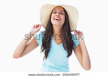 Happy young brunette wearing sunhat on white background