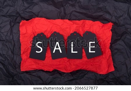 Top view of black 
 paper and discounts on red background and black background. Black Friday composition.