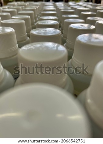 picture full of white plastic caps with their cans, sorted. close up. and different views