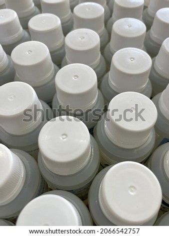 picture full of white plastic caps with their cans, sorted. close up. and different views