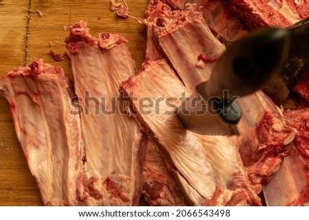 Knife is pierced in the ribs.The knife pierces the fresh meat. Royalty-Free Stock Photo #2066543498