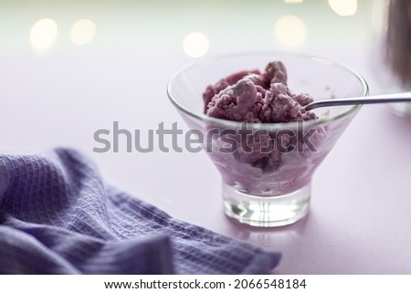 lavender ice cream on the background of festive lights