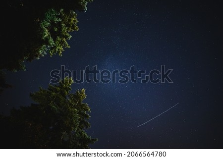 A meteor streaks across the star-filled sky during the Perseid Meteor Shower of 2021.