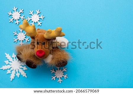 Christmass flatlay white snowflakes in shape frame and christmas deer 