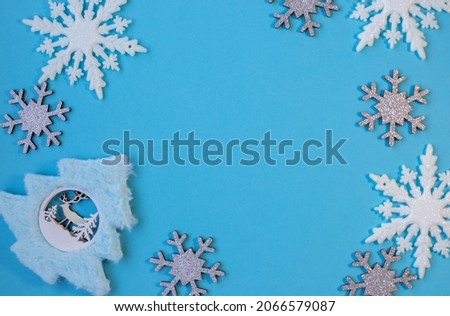 Christmass flatlay white snowflakes in shape frame and christmas tree 