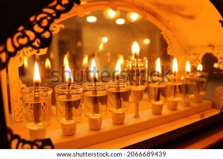 Religion image of jewish holiday Hanukkah background with menorah (traditional candelabra) and oil candles Royalty-Free Stock Photo #2066689439