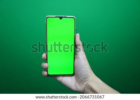 Hold smartphone on green screen