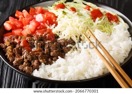 Takoraisu Taco rice is a Japanese dish hailing from Okinawa close-up in a bowl on the table. Horizontal
 Royalty-Free Stock Photo #2066770301