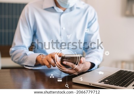 Business man hand holding smartphone device in cafe. 