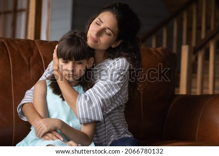 Worried mother hugging sad offended kid, consoling girl, giving comfort, support, empathy. Sympathetic loving mom embracing frustrated daughter kid with tenderness, care. Motherhood concept Royalty-Free Stock Photo #2066780132