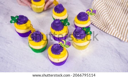 Step by step. Frosting vanilla cupcakes with Italian buttercream icing for Mardi Gras celebration.