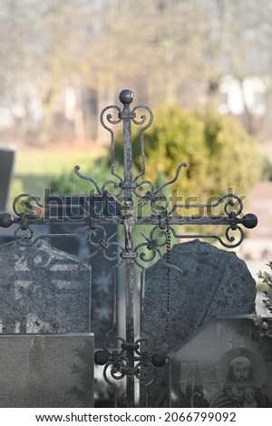 metal cross with decor motifs on a blurred background