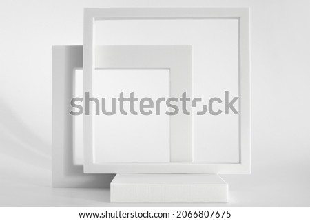 White podium on the white background, simple geometric forms. Podium for product, cosmetic presentation. Creative mock up. Pedestal or platform for beauty products. Royalty-Free Stock Photo #2066807675