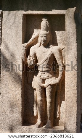 Bas relief of Pallava King sculpture carved in the monolithic rock cut cave temples in Mahabalipuram, Tamilnadu, India. Indian rock art of relief sculptures. Royalty-Free Stock Photo #2066813621